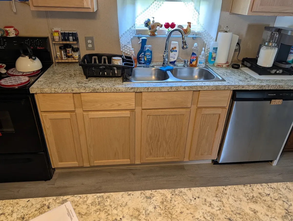 Remodeled kitchen with new oak cabinets, laminate countertops and vinyl plank flooring in Batavia, Ohio